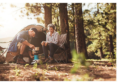Couple enjoying breakfast at their campsite